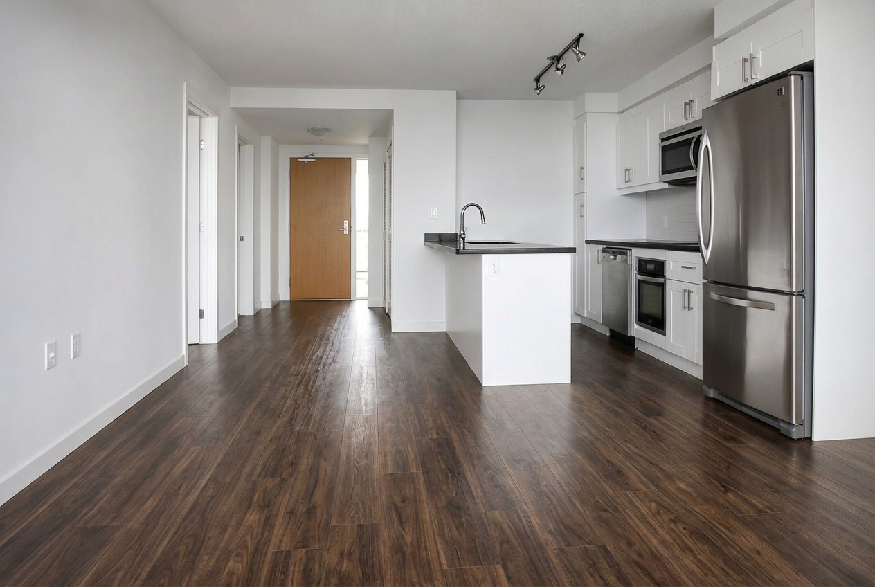 The same room with clean modern wide-plank wood-look flooring after renovation
